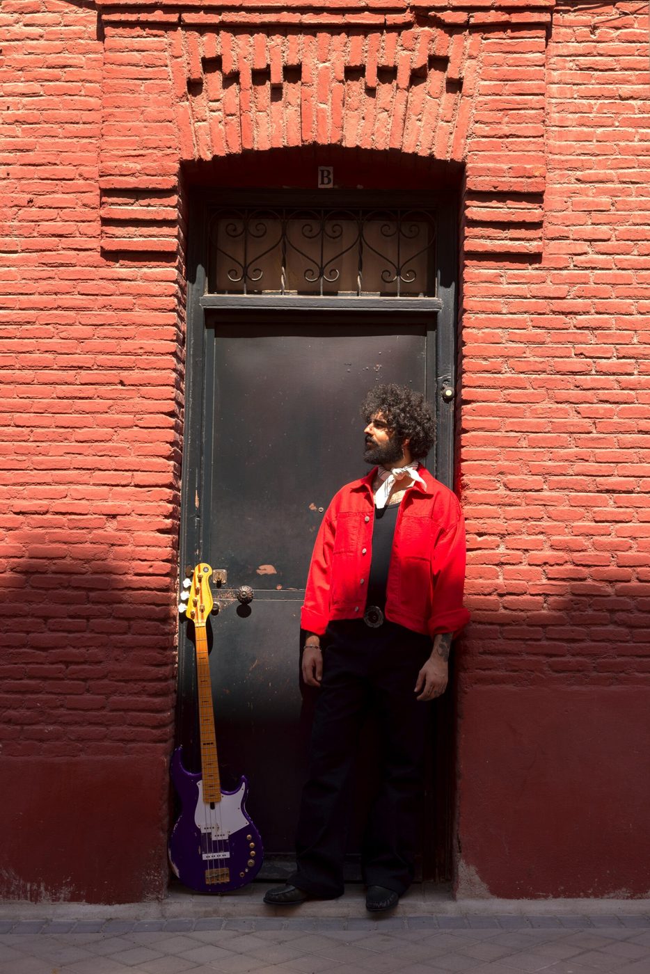 Vincen García in a red doorway